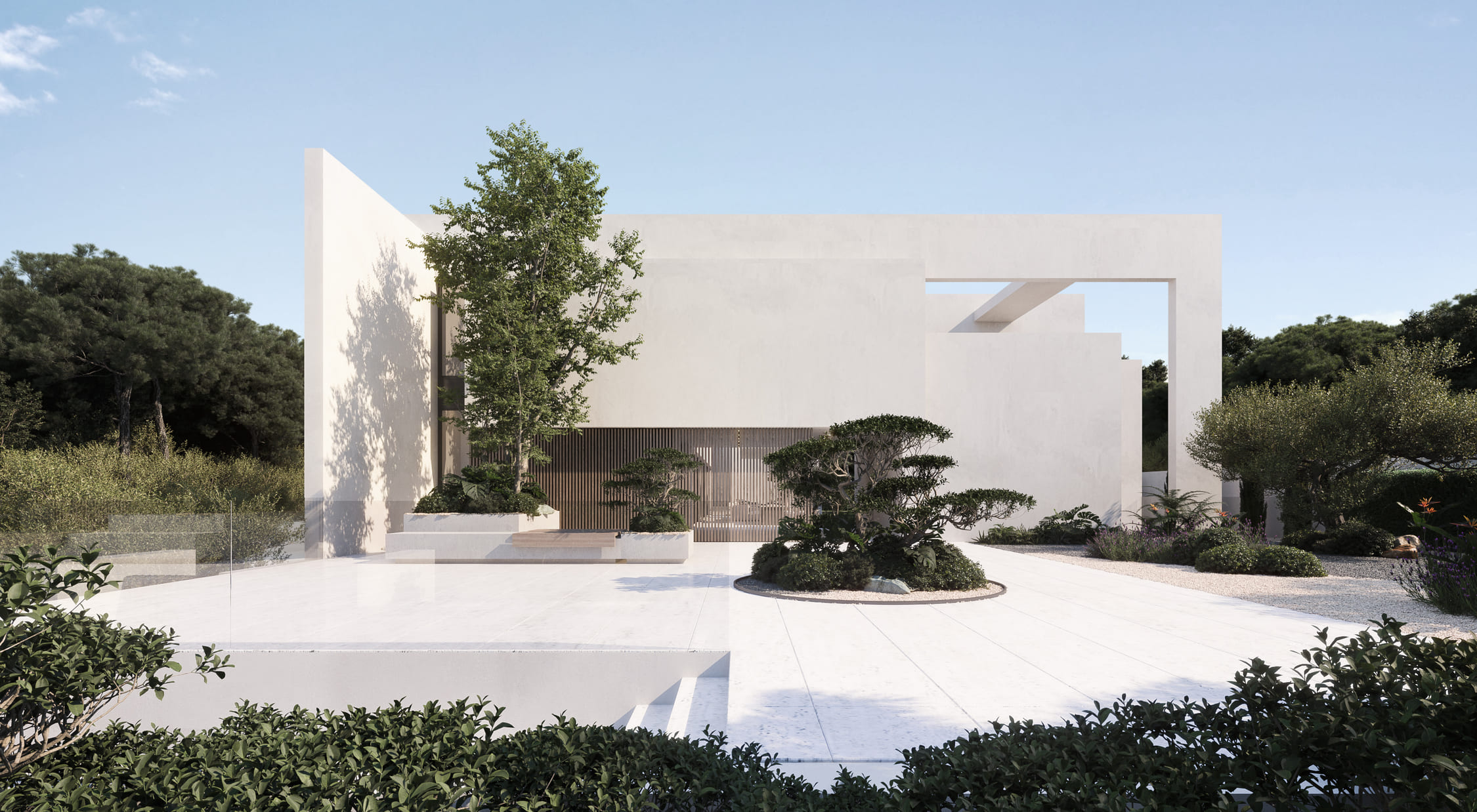 Fachada principal de la villa en Mijas con volúmenes blancos y jardín minimalista